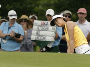 Michelle Wie chips onto the seventh green during the first round of the U.S. Women's Open Golf tournament Thursday, July 13, 2017, in Bedminster, N.J. (AP Photo/Seth Wenig)