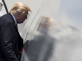 President Donald Trump boards Air Force One in Naval Air Station Norfolk, in Norfolk, Va Saturday, July 22, 2017, en route to Dulles International Airport, in Dulles, Va., after attending the commissioning ceremony of the aircraft carrier USS Gerald R. Ford (CVN 78). (AP Photo/Carolyn Kaster)