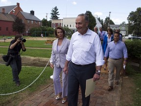 Senate Minority Leader Chuck Schumer of N.Y. and House Minority Leader Nancy Pelosi of Calif. lead Congressional Democrats to a news conference to unveil their new agenda, Monday, July 24, 2017, in Berryville, Va. House and Senate Democrats are offering a retooled message and populist agenda, promising to working Americans "someone has your back."  (AP Photo/Cliff Owen)