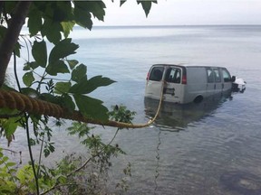 A van sits in Lake Erie on July 21, 2017 after it was driven off a cliff in Essex, Ont.