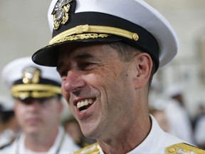 Commander of Naval Operations, Adm. John Richardson, speaks to reporters aboard the nuclear aircraft carrier USS Gerald R. Ford at Naval Station Norfolk in Norfolk, Va., Saturday, July 22, 2017. The ship will be commissioned by President Donald Trump later today. (AP Photo/Steve Helber)