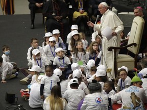 FILE - In this Thursday, Dec. 15, 2016 file photo, Pope Francis is surrounded by children as he speaks with patients and caregivers from the Vatican's Bambino Gesu Pediatric Hospital. During the audience in the Vatican's Paul VI hall, Francis exhorted hospital staff not to fall prey to corruption, which he called the "greatest cancer" that can strike a hospital. "Bambino Gesu has had a history that hasn't always been good," the pope said, jettisoning his prepared remarks to decry the temptation to "transform a good thing like a children's hospital into a business, and make a business where doctors become businessmen and nurses become businessmen, everyone's a businessman!" (AP Photo/Alessandra Tarantino)