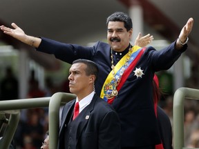 Venezuela's President Nicolas Maduro holds out his arms as arrives to attend a military parade commemorating the country's Independence Day in Caracas, Venezuela, Wednesday, July 5, 2017. Venezuela is marking 206 years of their declaration of independence from Spain. (AP Photos/Ariana Cubillos)