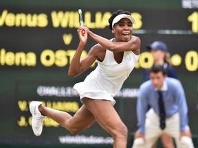 Venus Williams returns against Jelena Ostapenko during their match at Wimbledon on July 11.