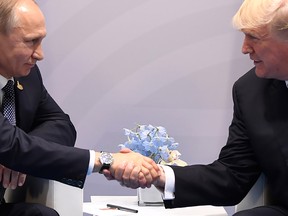 President Donald Trump and Russia's President Vladimir Putin shake hands during a meeting on the sidelines of the G20 Summit in Hamburg, Germany, on July 7, 2017.