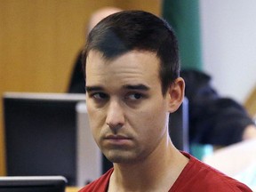 Cameron Espitia briefly glances toward a seating area as he leaves a courtroom after pleading not guilty to second-degree murder Thursday, July 13, 2017, in Seattle. Espitia, 31, is accused of fatally shooting his wife, Jennifer Espitia, 29, during an Uber ride in Seattle and remains jailed on $3 million bail following Thursday's appearance in King County Superior Court. Espitia told investigators he had been drinking and "having a bad night" but didn't remember what happened during the July 2 Uber ride, according to charging documents. (AP Photo/Elaine Thompson)