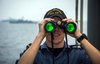 Able Seaman Kristian Sinclair spots flags on South Korean naval ships on joint exercise with HMCS Winnipeg.