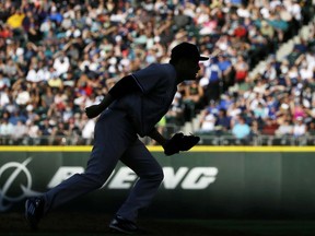 New York Yankees starting pitcher Masahiro Tanaka watches a throw to first base during the third inning of the team's baseball game against the Seattle Mariners, Saturday, July 22, 2017, in Seattle. (AP Photo/Ted S. Warren)