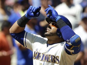 Seattle Mariners' Nelson Cruz looks up as he crosses the plate after he hit a three-run home run in the first inning of a baseball game against the New York Mets, Sunday, July 30, 2017, in Seattle. (AP Photo/Ted S. Warren)