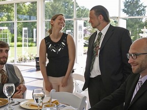 Sarah Cummins talks with men from Wheeler Mission, at the Ritz Charles, Saturday, July 15, 2017. C.