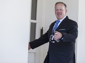 Sean Spicer, outgoing White House press secretary, gestures while entering the West Wing of the White House in Washington, D.C., U.S., on Tuesday, July 25, 2017.