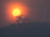 Smoke rises in front of the sun as a wildfire burns near Little Fort, B.C.