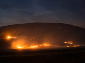 A wildfire burns on a mountain near Ashcroft, B.C., in the early morning hours of Saturday July 8, 2017. More than 3,000 residents have been evacuated from their homes in central British Columbia.