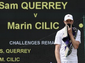 Sam Querrey of the United States waits for play to resume after a member of the crowd was taken ill as he plays against Croatia's Marin Cilic during their Men's Singles semifinal match on day eleven at the Wimbledon Tennis Championships in London, Friday, July 14, 2017. (AP Photo/Kirsty Wigglesworth)
