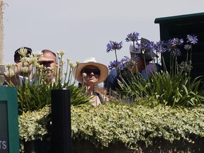 Spectators watch a match, on day five at the Wimbledon Tennis Championships in London Friday, July 7, 2017. (AP Photo/Kirsty Wigglesworth)