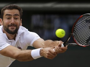 Croatia's Marin Cilic returns to Luxembourg's Gilles Muller during their Men's Singles Quarterfinal Match on day nine at the Wimbledon Tennis Championships in London Wednesday, July 12, 2017. (AP Photo/Alastair Grant)