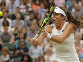 Britain's Johanna Konta returns to Romania's Simona Halep during their Women's Quarterfinal Singles Match on day eight at the Wimbledon Tennis Championships in London, Tuesday, July 11, 2017. (AP Photo/Alastair Grant)
