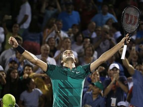 FILE - In this March 31, 2017, file photo, Roger Federer, of Switzerland, celebrates after defeating Nick Kyrgios, of Australia, in a tennis match at the Miami Open, in Key Biscayne, Fla. Federer extended his record with an 18th major championship in Australia, opened the year 19-1, took some time off and then won a grass title at Halle, Germany. With defending champion Andy Murray off-form this season, Federer is a popular pick to win Wimbledon for what would be a record eighth time.(AP Photo/Wilfredo Lee, File)