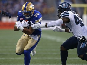 Blue Bombers running back Andrew Harris scores his second rushing touchdown of the game against the Toronto Argonauts during their game in Winnipeg on Thursday night.