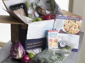 FILE - In this Oct. 6, 2014 file photo, an example of a home delivered meal from Blue Apron seen in Concord, N.H. Despite the old saying, you can buy happiness, especially if you spend it to save yourself time, new research finds.Researchers surveyed more than 6,000 people in four countries and found that people who doled out cash to save them time, housekeeping, grocery delivery services, taxis, were happier than those who don't.  (AP Photo/Matthew Mead, File)