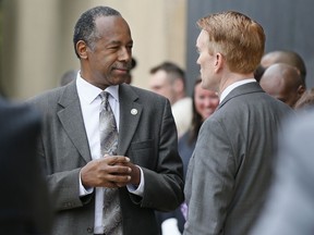 In this photo taken April 19, 2017, Housing and Urban Development Secretary Ben Carson, left, talks with Sen. James Lankford, R-Okla. in Oklahoma City, Oklahoma. Carson is pledging to "work toward a time when no family is without a home," even as the Trump administration seeks sharp budget cuts that critics say would lead to more people living on the streets.  (AP Photo/Sue Ogrocki)