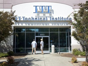 FILE - In this Sept. 6, 2016, file photo, Harold Poling, left, and Ted Weisenberger check the doors to the ITT Technical Institute after ITT Educational Services announced that the school had ceased operating in Rancho Cordova, Calif. The U.S. Education Department has not approved any applications for student-loan forgiveness in cases of possible fraud since President Donald Trump took office, according to records sent to an Illinois senator. The records also revealed that the department has continued to receive new applications from borrowers who say they were victims of fraud, mostly from Corinthian borrowers and from former students of ITT Technical Institute. (AP Photo/Rich Pedroncelli, File)