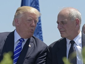 FILE - In this May 17, 2017, file photo, President Donald Trump talks with Homeland Security Secretary John Kelly during commencement exercises at the U.S. Coast Guard Academy in New London, Conn. Trump named Kelly as his new Chief of Staff on July 28, ousting Reince Priebus. (AP Photo/Susan Walsh)