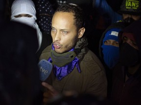 Oscar Perez speaks to the press at a night vigil to honor the more than 90 people killed during three months of anti-government protests, in Caracas, Venezuela, Saturday, July 13, 2017. The Venezuelan police officer who stole a helicopter and fired on two government buildings appeared in public for the first time Thursday night, defying a nationwide manhunt.