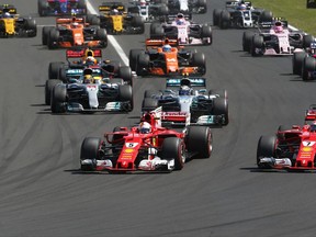 Ferrari driver Sebastian Vettel of Germany, center, leads into the first curve at the start of the Hungarian Formula One Grand Prix, at the Hungaroring racetrack in Mogyorod, northeast of Budapest, Sunday, July 30, 2017. (AP Photo/Darko Bandic)
