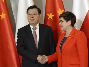 Chairman of the Standing Committee of China's National People's Congress Zhang Dejiang, left, shakes hands with Polish Prime Minister Beata Szydlo prior to talks in Warsaw, Poland, Thursday, July 13, 2017. (AP Photo/Alik Keplicz)