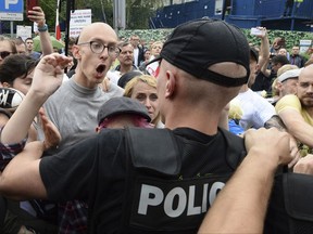 Protesters confront police in front of the parliament after lawmakers voted to approve a law on court control, in Warsaw, Poland, Thursday, July 20, 2017. The bill on the Supreme Court has drawn condemnation from the European Union and has led to street protests in Warsaw, Poland, Thursday, July 20, 2017. (AP Photo/Alik Keplicz)