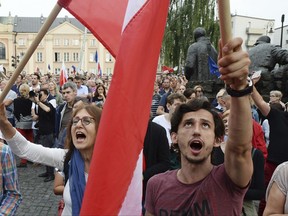 Opposition supporters protest in front of the Supreme Court against a law on court control , in Warsaw, Poland, Friday, July 21, 2017. The bill on the Supreme Court has drawn condemnation from the European Union and has led to street protests in Warsaw. (AP Photo/Alik Keplicz)