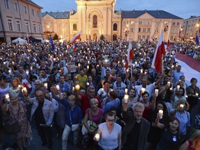 People gather for candle lit protest in front of the Supreme Court in Warsaw, Poland, Monday, July 24, 2017. Polish President Andrzej Duda announced earlier that he will veto two contentious bills widely seen as assaults on the independence of the judicial system, but the protesters demand a veto for a third bill. (AP Photo/Alik Keplicz)