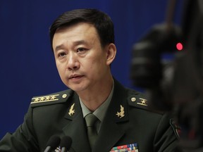 China's defense ministry spokesman Wu Qian speaks during a news conference at the State Council Information Office in Beijing, Monday, July 24, 2017. China is warning India not to underestimate its determination to safeguard what it considers sovereign territory amid an ongoing standoff between the two neighbors over a contested region high in the Himalayas. (AP Photo/Andy Wong)