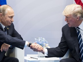 U.S. President Donald Trump, right, and Russian President Vladimir Putin shake hands during the G20 summit in Hamburg Germany, Friday July 7, 2017. (AP Photo/Marcellus Stein)
