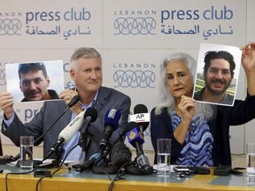Marc and Debra Tice, the parents of Austin Tice, who is missing in Syria for nearly five years, hold up photos of him during a press conference, at the Press Club, in Beirut, Lebanon, Thursday, July 20, 2017. The Tices said Thursday that the U.S. and Syrian governments have assured them that they are doing all they can to secure his safe release adding that they are ready to deal with any government or group that will help them win the freedom of their son. (AP Photo/Bilal Hussein)