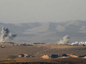 This frame grab from video released on Friday, July 21, 2017 and provided by the government-controlled Syrian Central Military Media, shows smoke rising while Hezbollah cannons pounding militants' positions on the Lebanon-Syria border. The Syrian army and members of Lebanon's militant Hezbollah group launched a major ground offensive on Friday aiming to end years long presence of hundreds of militants in a border area between the two countries. (Syrian Central Military Media, via AP)