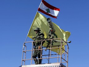 A Hezbollah fighter stands at a watchtower at the site where clashes erupted between Hezbollah and al-Qaida-linked fighters in Wadi al-Kheil or al-Kheil Valley in the Lebanon-Syria border, Saturday, July 29, 2017. A cease-fire went into effect between the militant Hezbollah group and al-Qaida-linked fighters on Thursday morning as negotiations were underway to reach a deal that would eventually lead to the evacuation of Syrian fighters to the northwestern rebel-held province of Idlib. The truce followed a six-day offensive by Hezbollah and Syrian troops who besieged al-Qaida-linked fighters in a small border area. (AP Photo/Bilal Hussein)