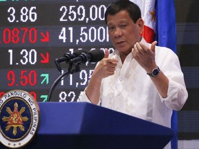 Philippine President Rodrigo Duterte gestures while addressing stock traders during his visit for the first time at the Philippine Stocks Exchange to mark the 10th anniversary of the stock listing of Phoenix Petroleum at the financial district of Makati city, east of Manila, Philippines, Tuesday, July 11, 2017. Duterte said a disastrous siege by Islamic State group-aligned gunmen on a southern city of Marawi may end in 10 to 15 days but the threat posed by the brutal group will continue to plague the country. (AP Photo/Bullit Marquez)