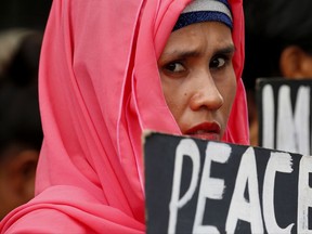 A protester displays a placard during a rally outside the Lower House as lawmakers gather for a special joint session on the possible extension of martial law in the southern Philippines, Saturday, July 22, 2017 in Quezon city, northeast of Manila, Philippines. Martial Law was declared by President Duterte last May 23 for 60 days following the siege by Muslim militants of Marawi city which is now on its second month. (AP Photo/Bullit Marquez)