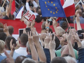 Opposition supporters protest in front of the presidential palace, urging President Andrzej Duda to reject a bill voted by lawmakers on court control, in Warsaw, Poland, Thursday, July 20, 2017.  The bill on the Supreme Court has drawn condemnation from the European Union and has led to street protests in Warsaw.(AP Photo/Czarek Sokolowski)