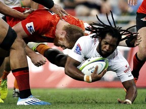 FILE -- in this March 12, 2016 file photo South Africa's Sergeal Petersen of the Cheetahs is tackled by Japan's Ed Quirk of the Sunwolves during their Super Rugby match Singapore. The South African rugby union has confirmed what has already widely expected, the Cheetahs and Southern Kings will be dropped from Super Rugby next season. (AP Photo/Wong Maye-E, File)