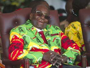 FILE -- In this Friday June, 2, 2017 file photo Zimbabwean President Robert Mugabe smiles during a youth rally in Marondera, east of Harare.  Zimbabwe State media, quoting an information ministry statement, says the world's oldest head of state is in Singapore for medical reasons, prompting opposition figures to question whether the 93-year-old still has the stamina to run the country. (AP Photo/Tsvangirayi Mukwazhi, File)