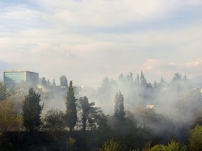 Smoke rises over the Montenegro capital Podgorica, on Sunday, July 16, 2017. Firefighters in Croatia and Montenegro have been struggling to contain wild fires that have erupted along the Adriatic coast in the two countries at the height of the tourism season. (AP Photo/Risto Bozovic)