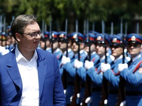 In this photo taken Tuesday, June 20, 2017, Serbia's President Aleksandar Vucic reviews the honor guard during a welcoming ceremony at the army barracks in Pancevo, some 16 kilometers (10 miles) north of Belgrade, Serbia. Serbia's president says the Balkan country must resolve its relations with the breakaway former province of Kosovo in order to move forward. (AP Photo/Darko Vojinovic)