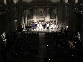 Tenor Andrea Bocelli performs with the "Voices of Haiti" children's choir during the concert that inaugurates the Franco Zeffirelli International Center For Performing Arts, in Florence, Italy, Monday, July 31, 2017. The center, besides its educational activities, brings together the entire artistic and cultural patrimony of the Italian director's almost 70-year career, including over ten thousand books from his personal library, thousands of professional documents and notes, designs, sketches, scripts, screenplays and storyboards, as well as a substantial collection of photographs of his works from the post-war years to present days. (AP Photo/Domenico Stinellis)