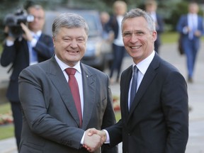 Ukrainian President Petro Poroshenko, left, and NATO Secretary General Jens Stoltenberg, shakes hands during a meeting in Kiev, Ukraine, Monday, July. 10, 2017. (AP Photo/Efrem Lukatsky)