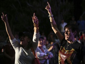 Opposition members shout slogans against Venezuela's President Nicolas Maduro as they waits for the results of a of a symbolic referendum in Caracas, Venezuela, Sunday, July 16, 2017. Hundreds of thousands of Venezuelans lined up across the country and in expatriate communities around the world Sunday to vote in a symbolic rejection of President Maduro's plan to rewrite the constitution, a proposal that's raising tensions in a nation battered by shortages and anti-government protests. (AP Photo/Jesus Hernandez)