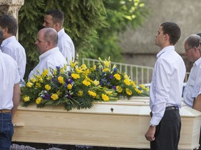 The coffin with the frozen bodies is carried  in front of the church for the funeral of Marcelin and Francine Dumoulin in Saviese, Switzerland, Saturday, July 22, 2017. The couple Marcelin and Francine Dumoulin have been missing since August 15, 1942. Nearly 75 years later, the frozen bodies of this couple have been found last week on the Tsanfleuron Glacier.  (Dominic Steinmann/Keystone via AP)