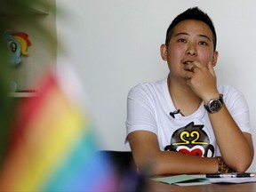 FILE - In this May 18, 2016, file photo, a transgender equal rights supporter who goes by the name of "Mr. C" pauses during an interview in Beijing. The 29-year-old man, who identifies himself only as "Mr. C" to protect his parents' privacy, said the verdict on Thursday, July 27, 2017, by a district court in the southwestern city of Guiyang ruled his employment rights were violated. It ordered his previous employer, Ciming Checkup, pay him the equivalent of $297 in the country's first such discrimination lawsuit. (AP Photo/Andy Wong, File)